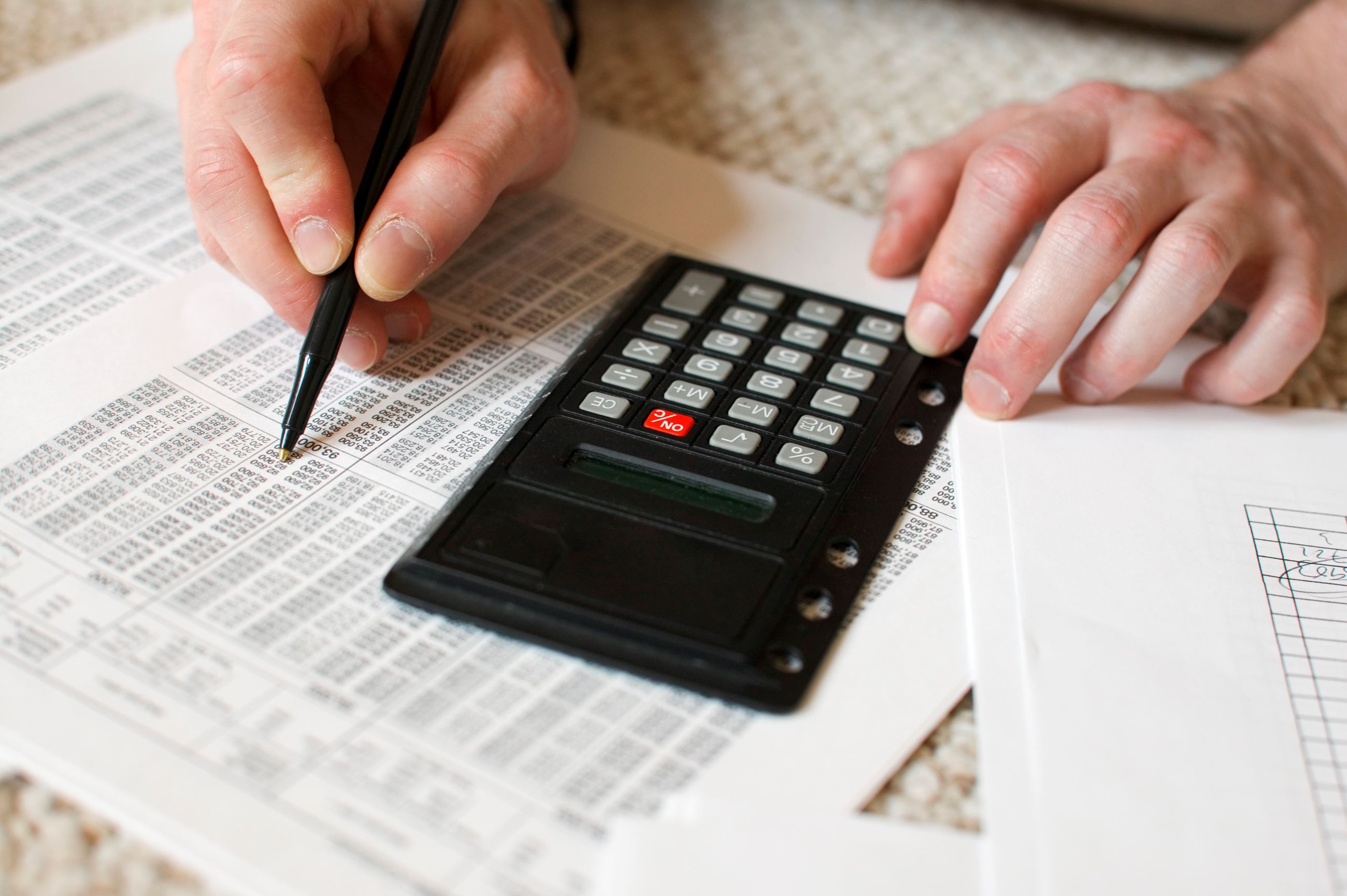 man-s-hands-and-calculator-2421961